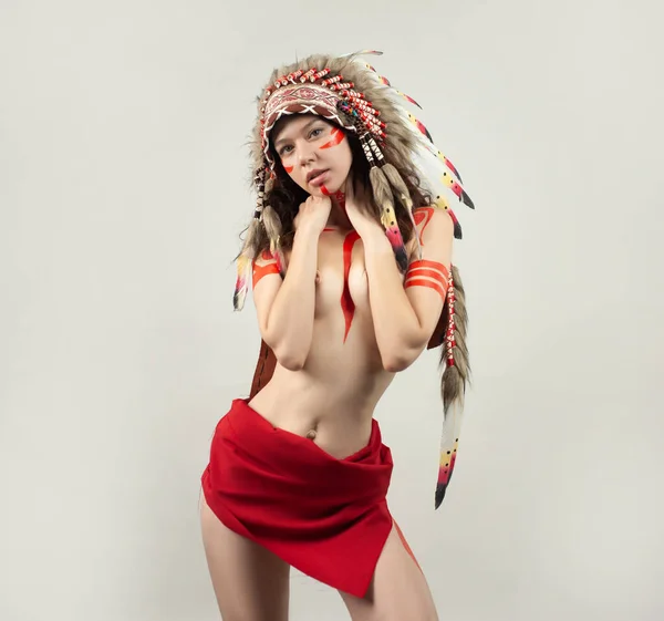 naked woman in native american costume with feathers