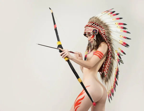 naked woman in native american costume with feathers