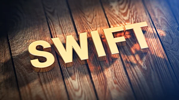 Palabra SWIFT sobre tablones de madera —  Fotos de Stock