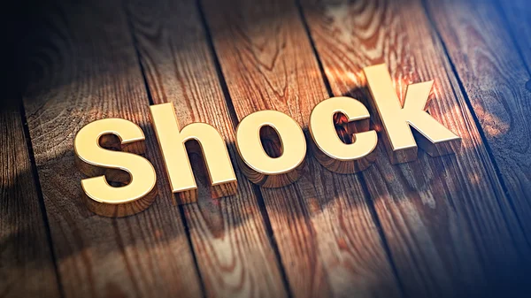 Palavra Choque em tábuas de madeira — Fotografia de Stock