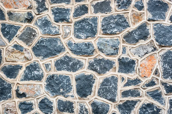 Wall of black natural stones — Stock Photo, Image