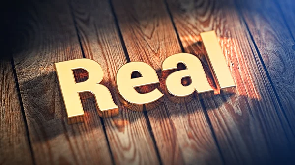 Ordet Real på trä plankor — Stockfoto