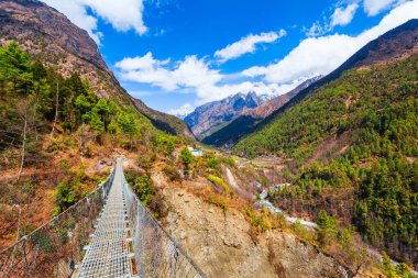 Bridge through the river in Everest or Khumbu region in Himalaya mountains, Nepal clipart