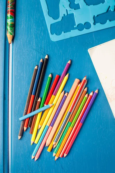 Pencils, stencil, paper, drawing lie on a table Royalty Free Stock Photos