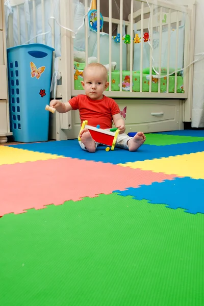 A criança brinca com o pai um brinquedo de madeira com um martelo e o — Fotografia de Stock