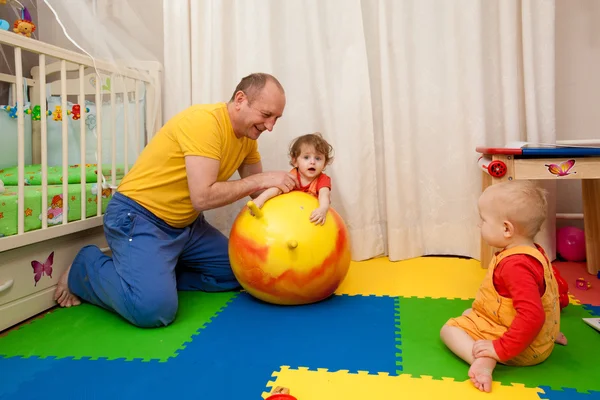 The boy and the girl play on a nursery floor — Stock Photo, Image