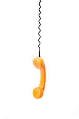 Beyaz arka plan üzerinde izole turuncu retro telefon tüp.