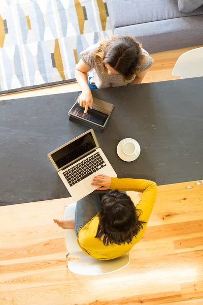 young women at home studying