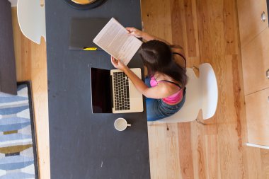 Evde çalışan genç bir kadın. 