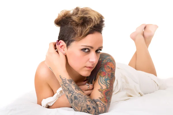 Tattooed Woman in bed — Stock Photo, Image