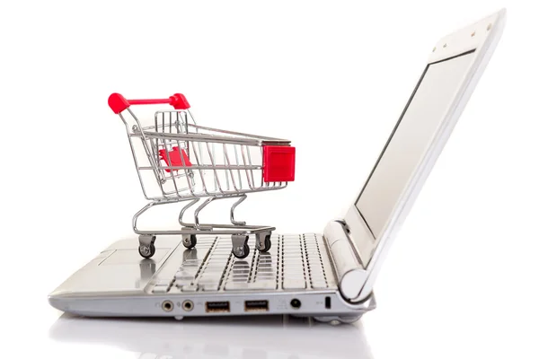 Shopping cart over a laptop — Stock Photo, Image