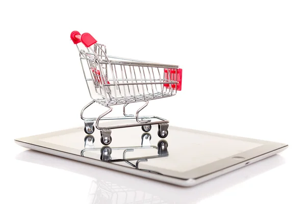 Shopping cart over a tablet — Stock Photo, Image