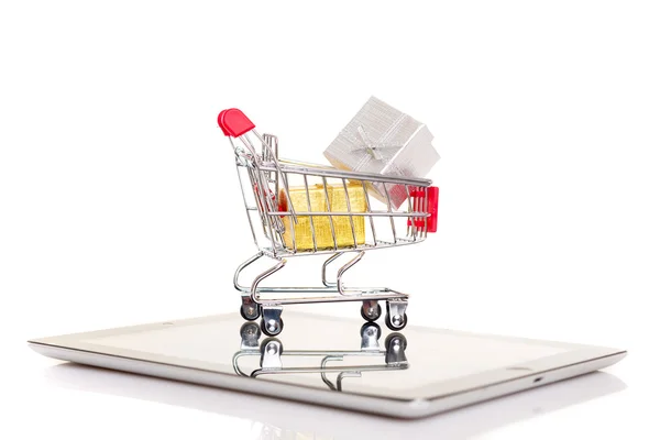 Shopping cart over a tablet — Stock Photo, Image