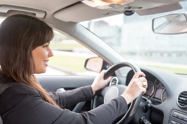 Woman driving new car — Stock Photo, Image
