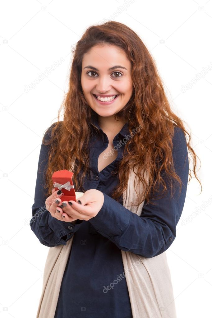 Surprised woman holds gift box