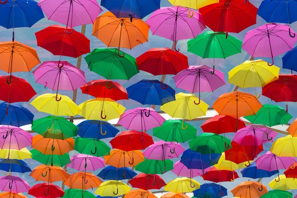 Lots of umbrellas coloring the sky — Stock Photo, Image