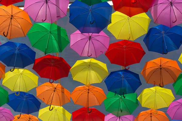 Lots of umbrellas coloring the sky — Stock Photo, Image