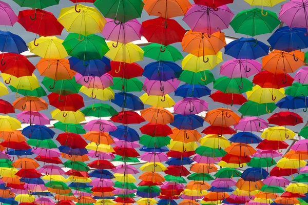 Lots of umbrellas coloring the sky — Stock Photo, Image