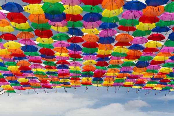 Lots of umbrellas coloring the sky — Stock Photo, Image