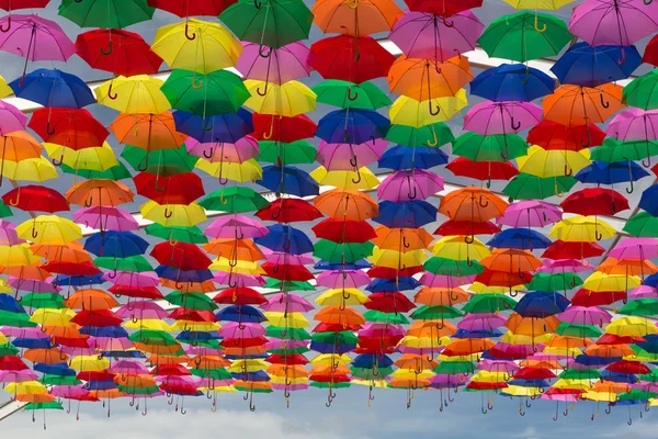 Lots of umbrellas coloring the sky — Stock Photo, Image