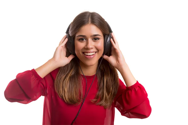Kvinna lyssnar på musik i hörlurar — Stockfoto