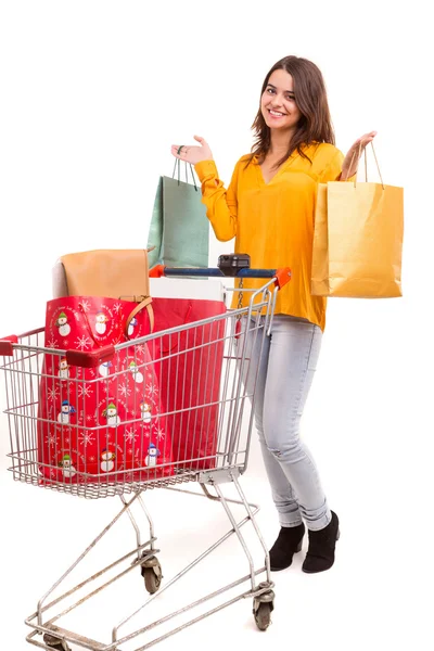 Woman with shopping cart full of gifts — Stock Photo, Image