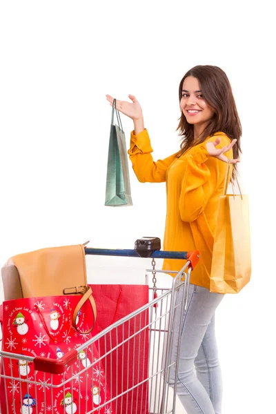 Woman with shopping cart full of gifts — Stock Photo, Image