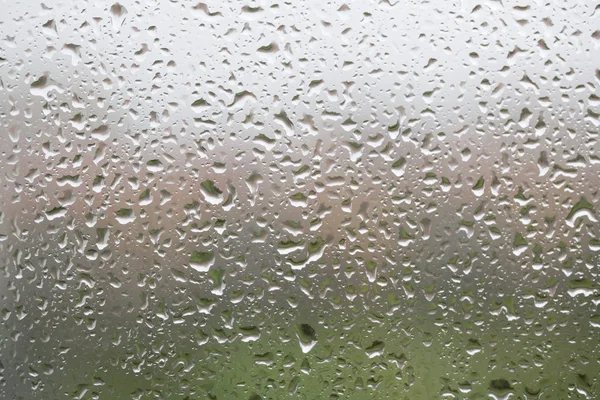 Glass surface with water drops in a rainy day — Stock Photo, Image
