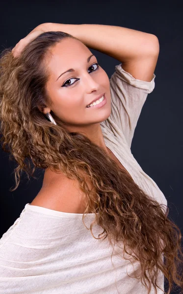 Young beautiful brunette portrait against dark background — Stock Photo, Image