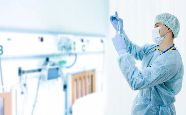 Unga manliga läkare med en spruta på sjukhuset — Stockfoto