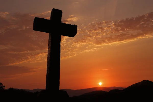 Cross silhouette and the clouds at sunset — Stock Photo, Image