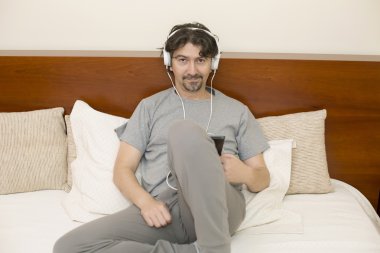 Yatak odasında yalan ise tablet bilgisayar kullanan adam