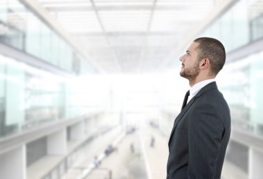 Genç iş adamı ofiste düşünüyor.