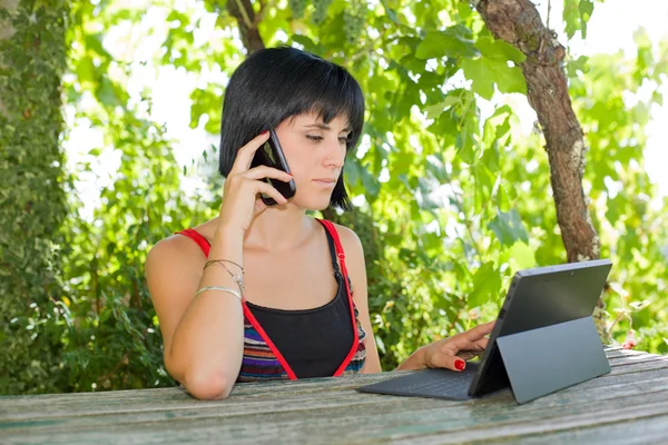 Mujer casual que trabaja con una tableta PC, al aire libre — Foto de Stock