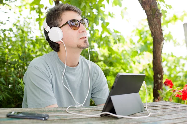 Casual uomo che lavora con un tablet pc, all'aperto — Foto Stock