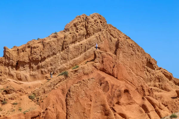 Issyk Kul Κιργιστάν Άνθρωποι Στους Σχηματισμούς Κόκκινων Πετρωμάτων Από Ψαμμίτη — Φωτογραφία Αρχείου