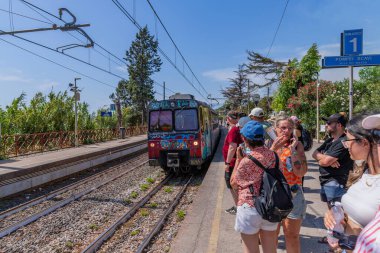 Pompeii, Italy: Crowd of people on Platform 1 of Pompeii Scavi station waiting to catch a train to Sorrento