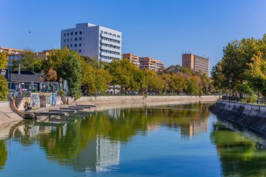 Bükreş, Romanya: Bükreş 'teki Dambovita Nehri' nin arka planda binalarla huzurlu bir manzarası. Romanya