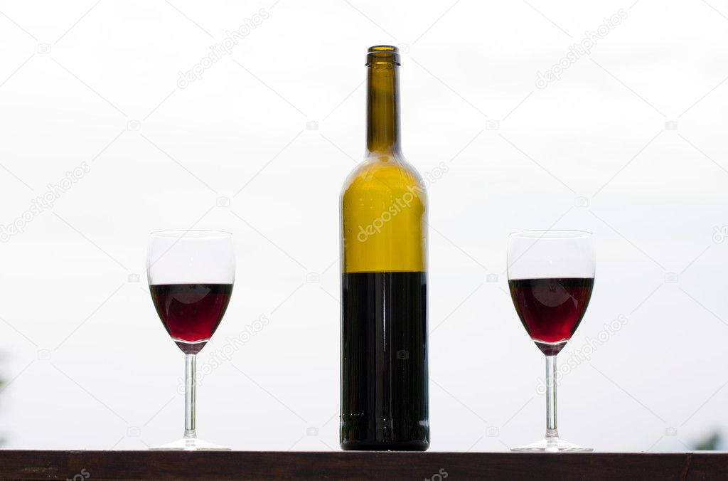 Red wine in glasses with bottle, outdoor