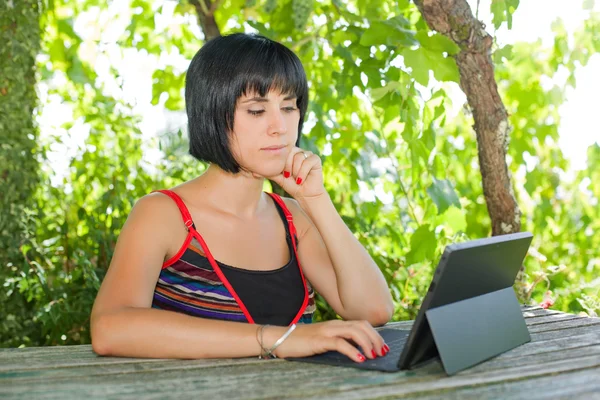 Mulher casual trabalhando com um tablet pc, ao ar livre — Fotografia de Stock