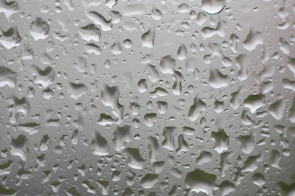 Glass surface with water drops in a rainy day — Stock Photo, Image