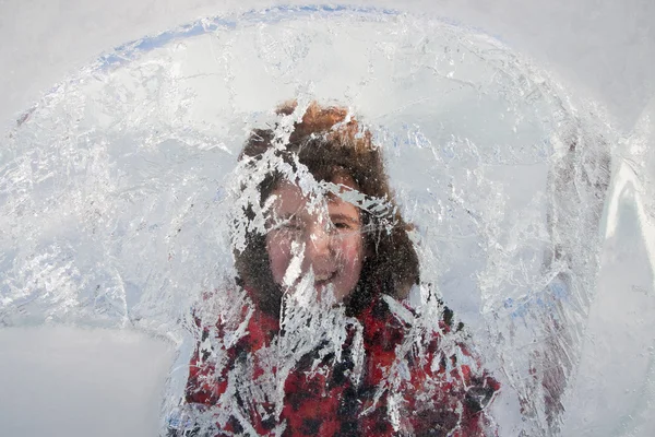 The boy looks through the ice sculpture — Stock Photo, Image