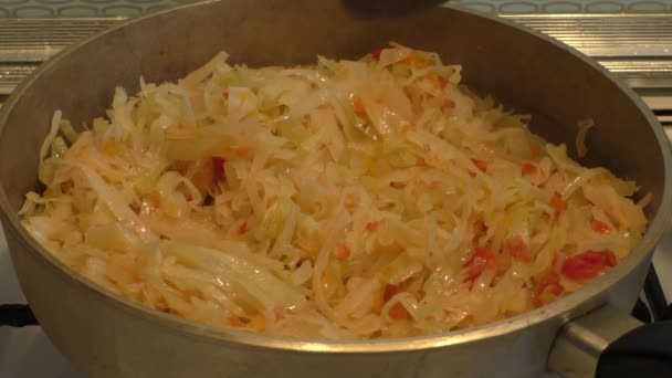 The woman prepares for stewed cabbage — Stock Video