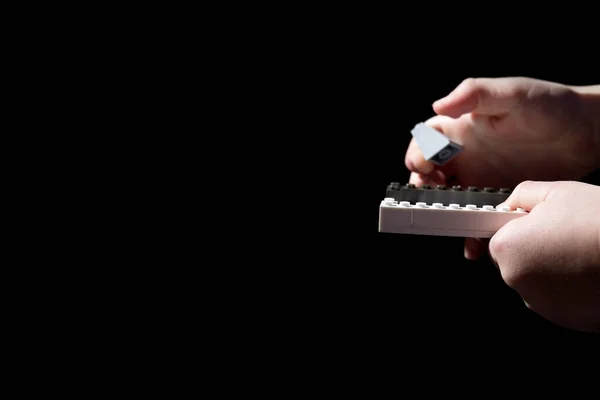 Child Hands Hold Clastic Constructor Bricks Close Isolated Black Copy — Stock Photo, Image