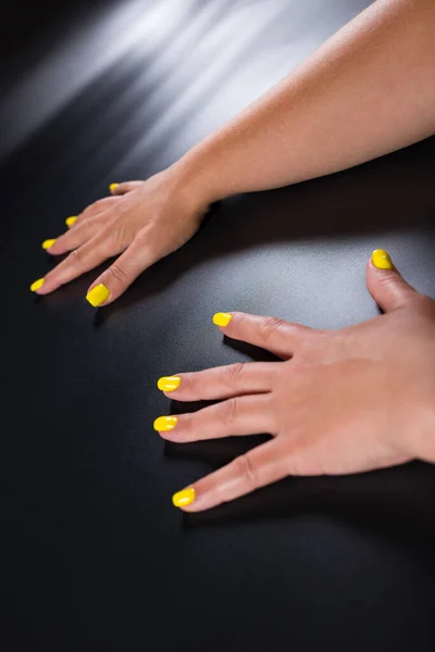 Tanned Female Hands Yellow Manicure Black Background — Stock Photo, Image