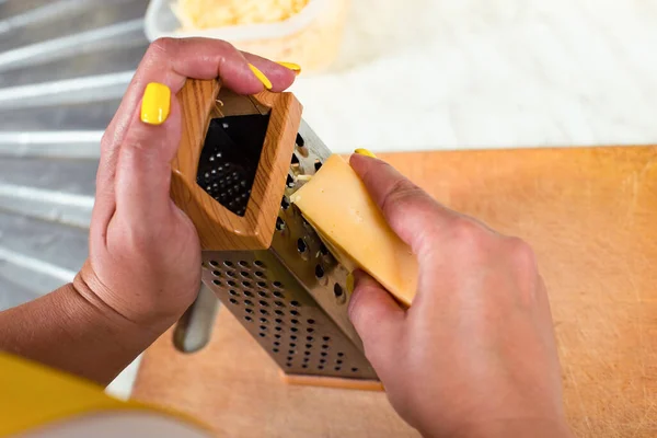 Female Hands Grate Cheese Grater Close Yup Wooden Board — Stock Photo, Image