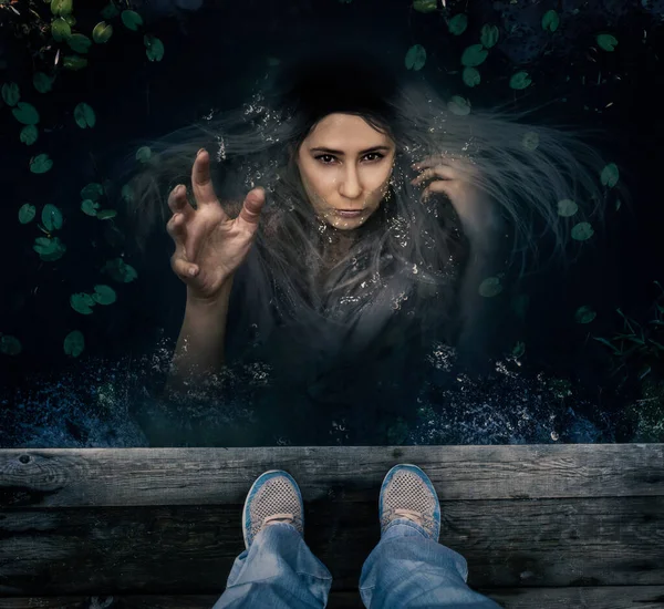 siren character reaches out of the water to drag a person to the bottom. character for halloween. book cover.