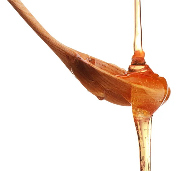 Miel goteando de un cazo de madera — Foto de Stock