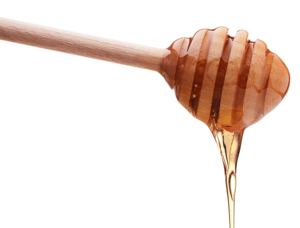 Honey dripping from a honey dipper — Stock Photo, Image