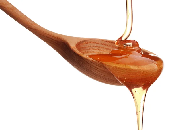 Honey dripping from spoon — Stock Photo, Image